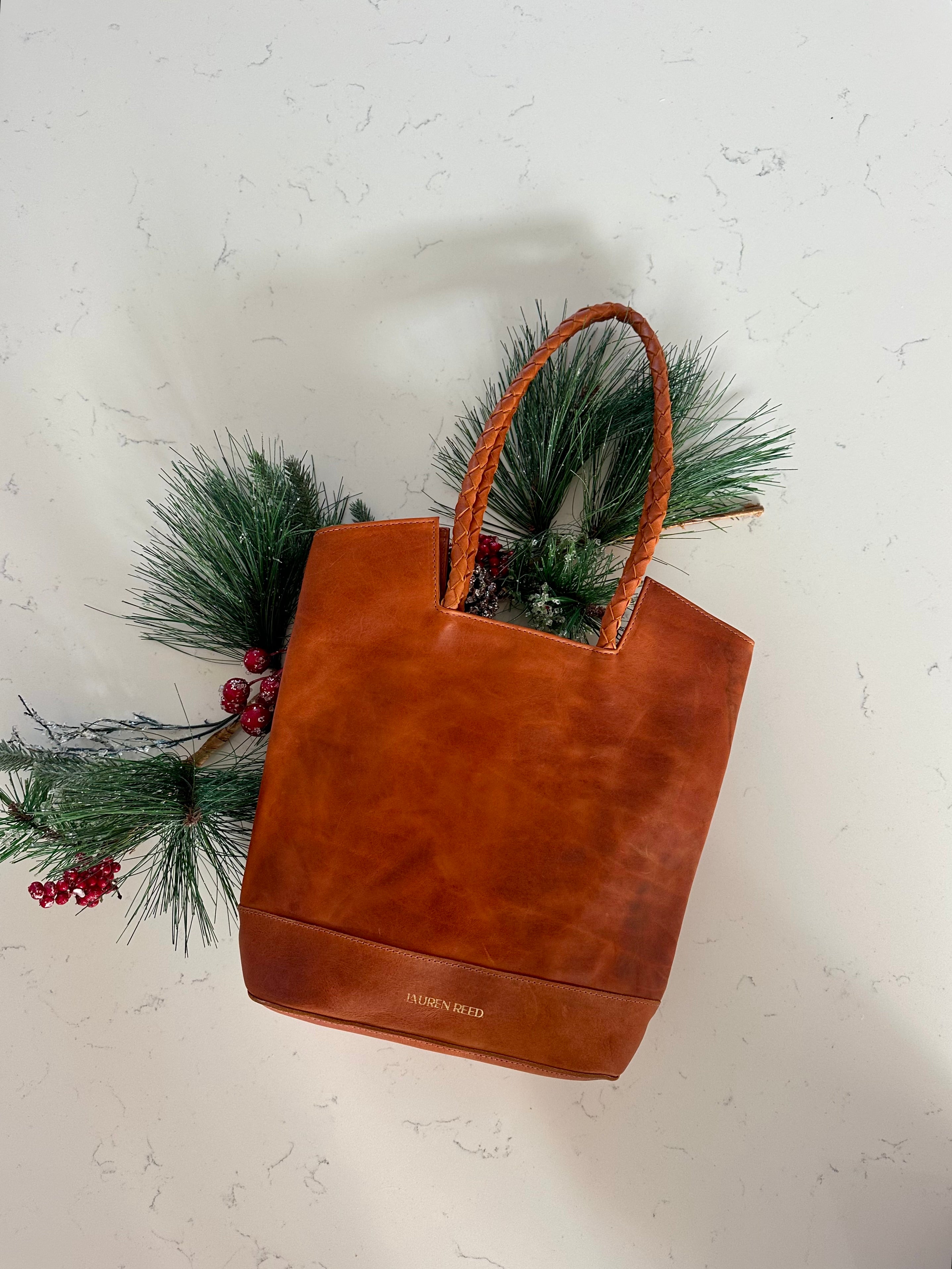 Tan leather tote bag with holiday decor
