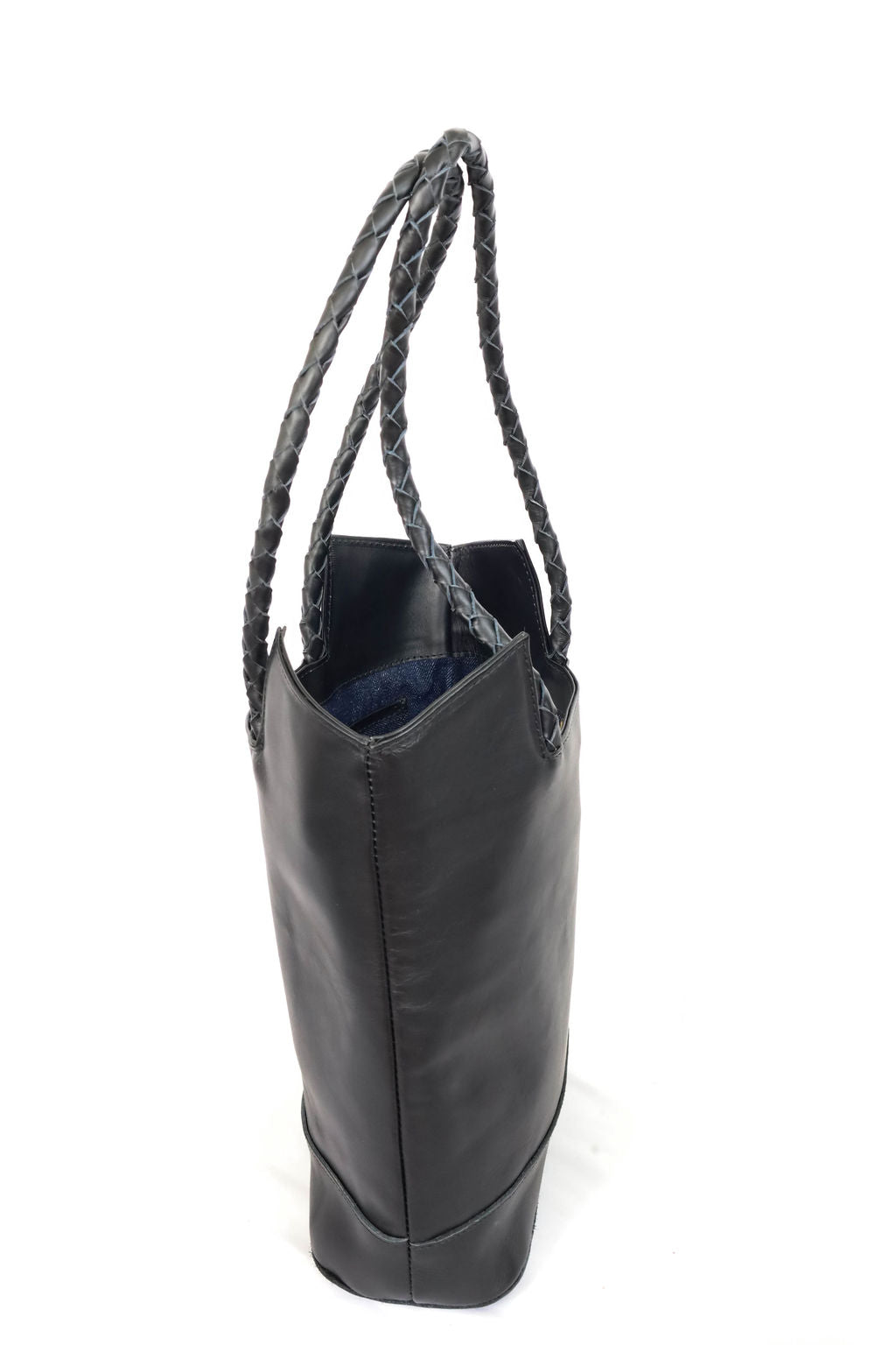 Black leather tote bag with braided handle on a white background