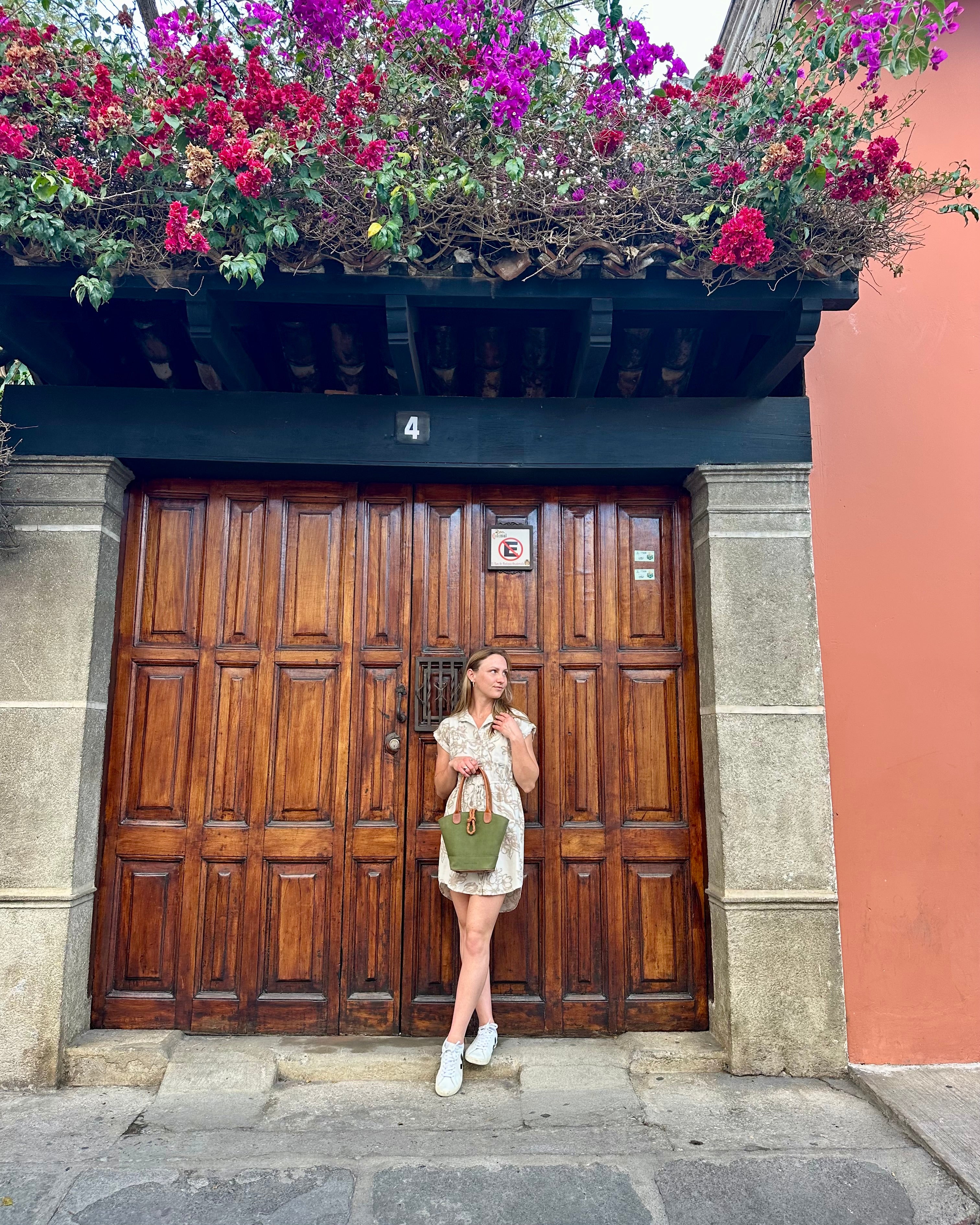 Lauren Reed holding Green Leather Crossbody Purse in Guatemala