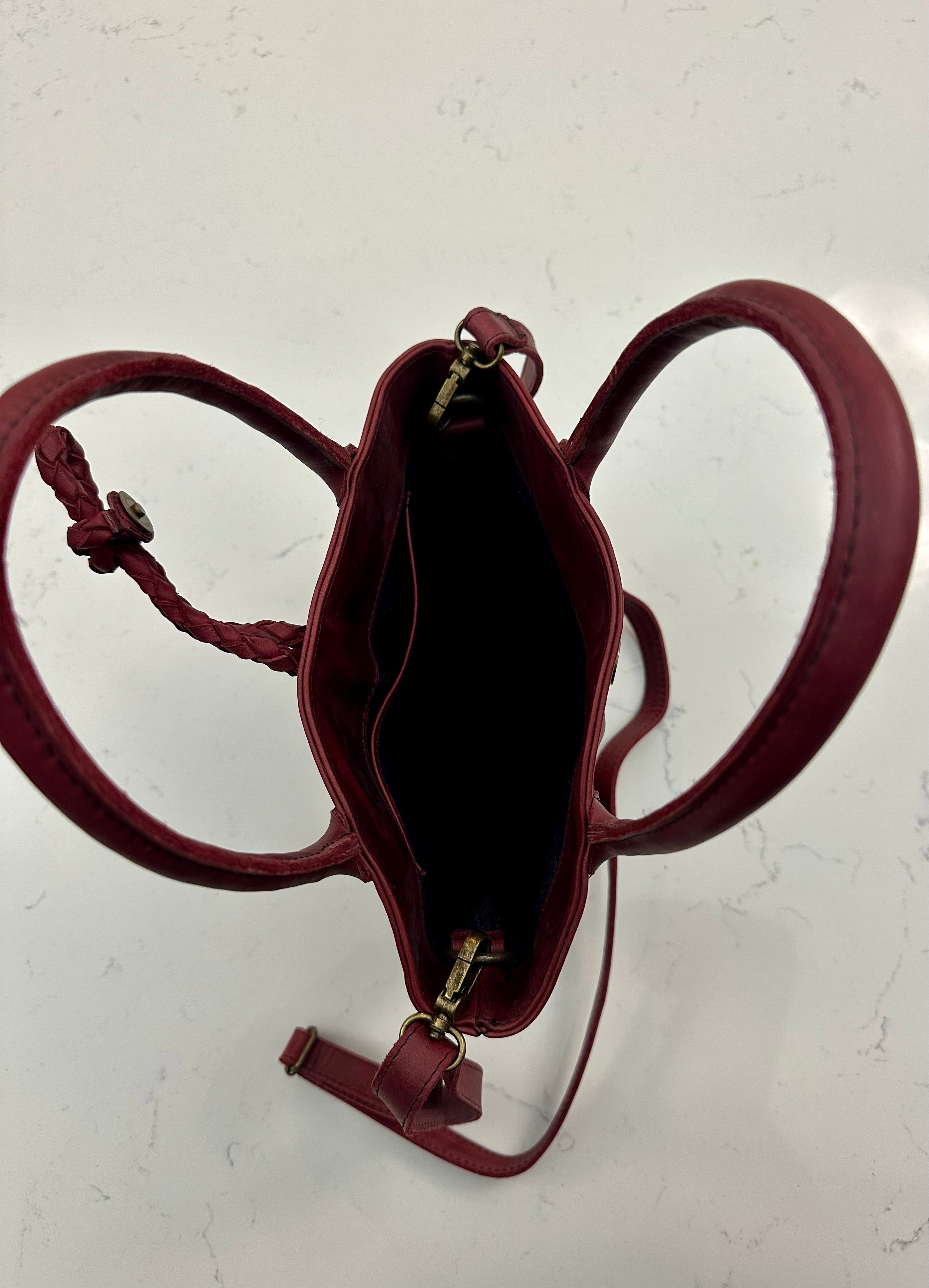 Red leather handbag on a light background