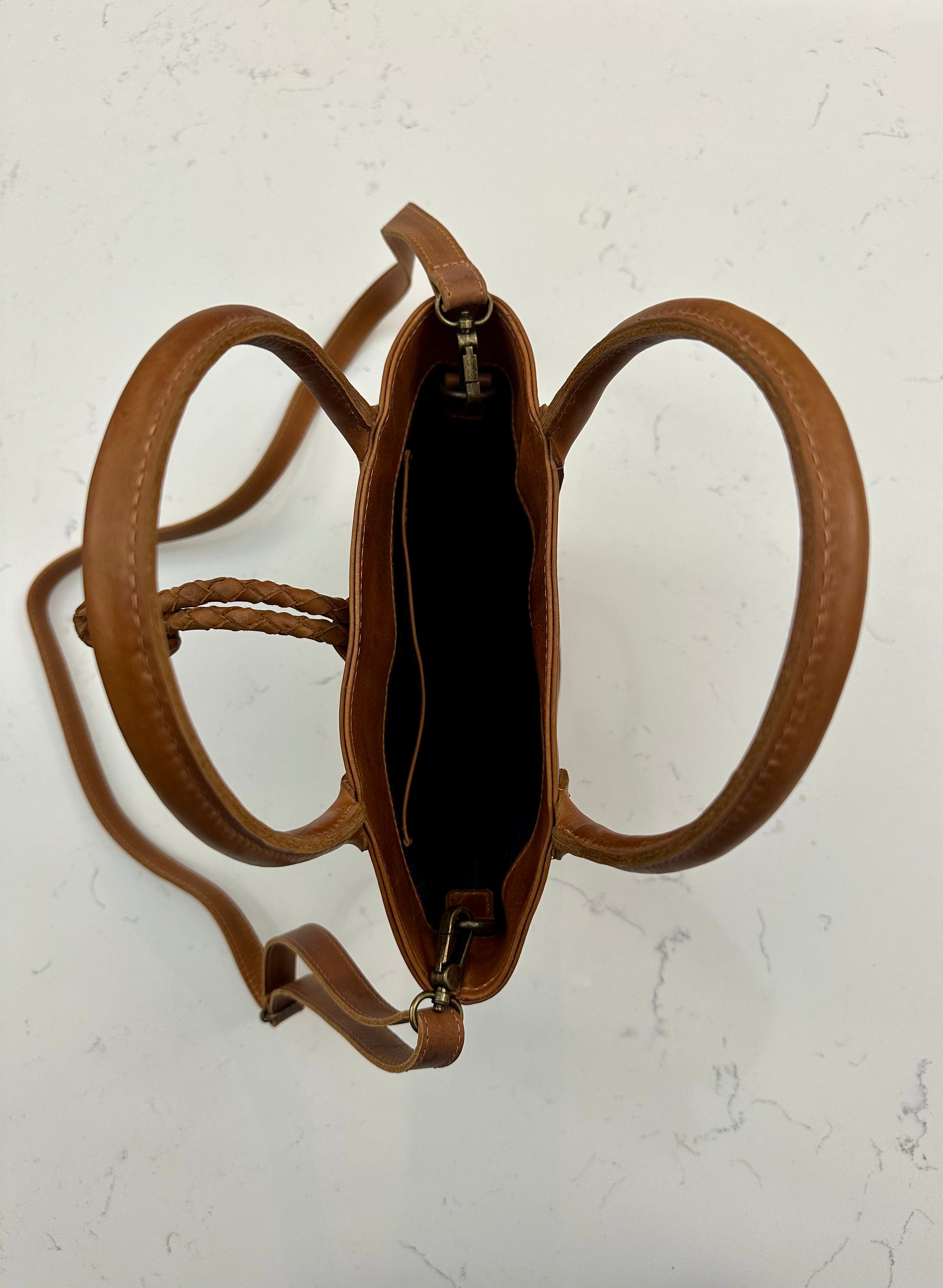 Tan leather handbag on a light background