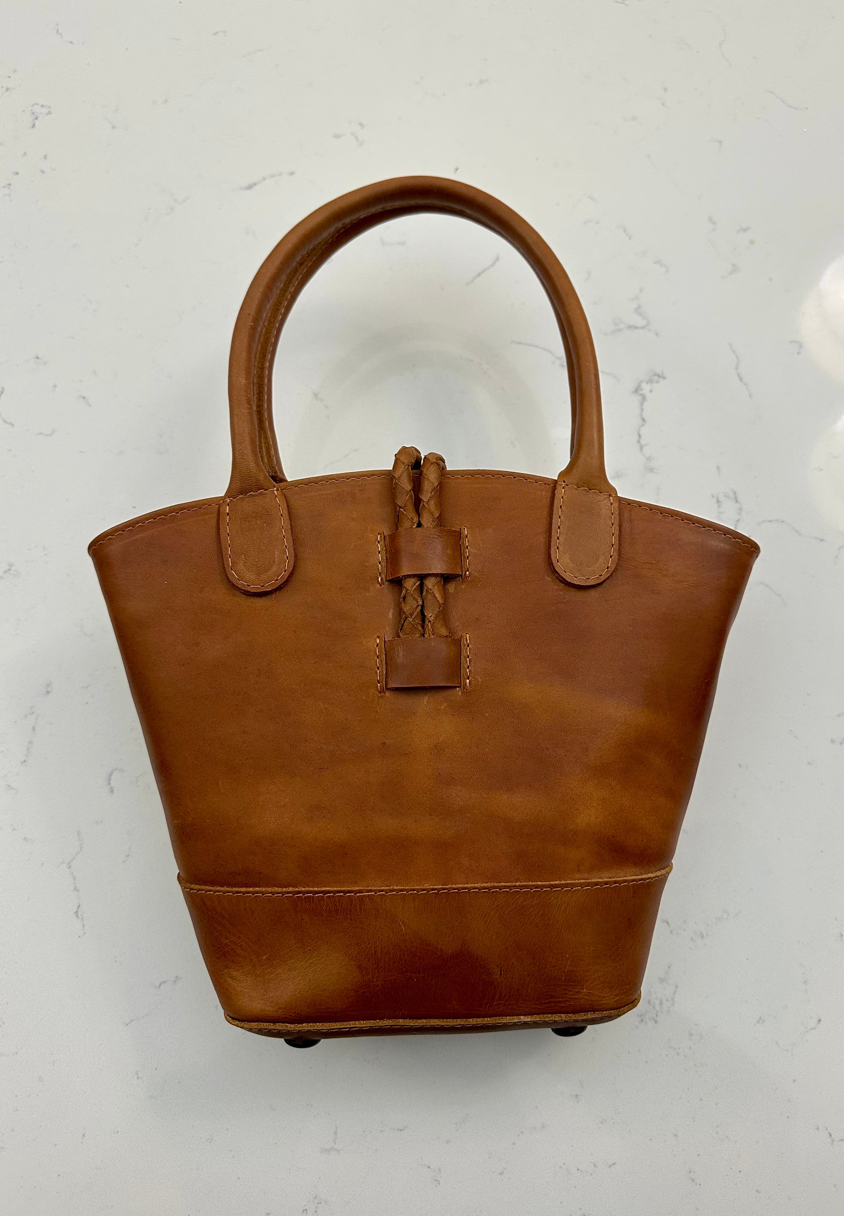 Tan leather handbag on a light background