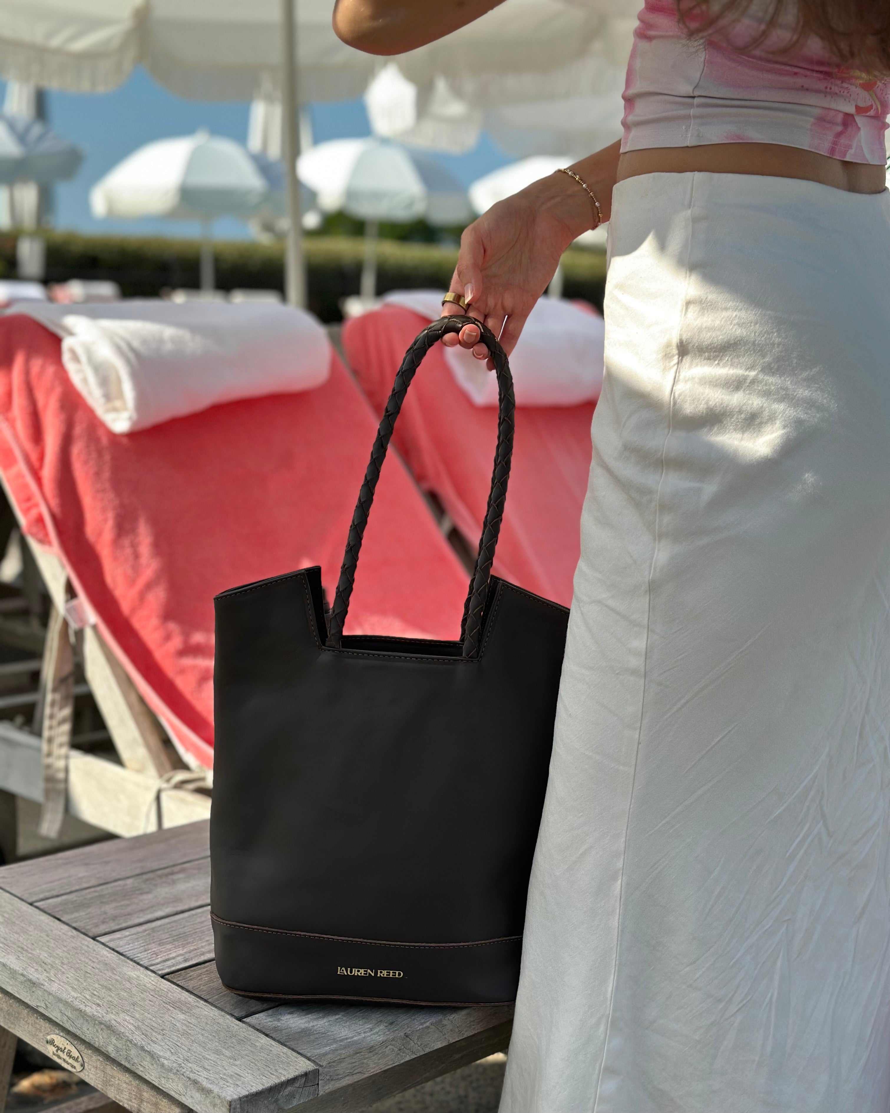 Leather tote bag styled by poolside resort