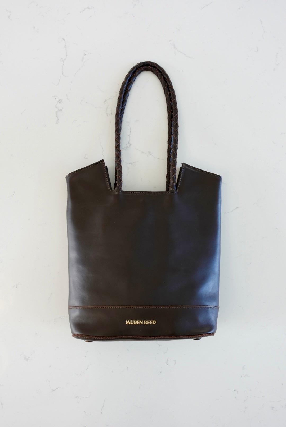 Espresso brown leather tote bag on marble