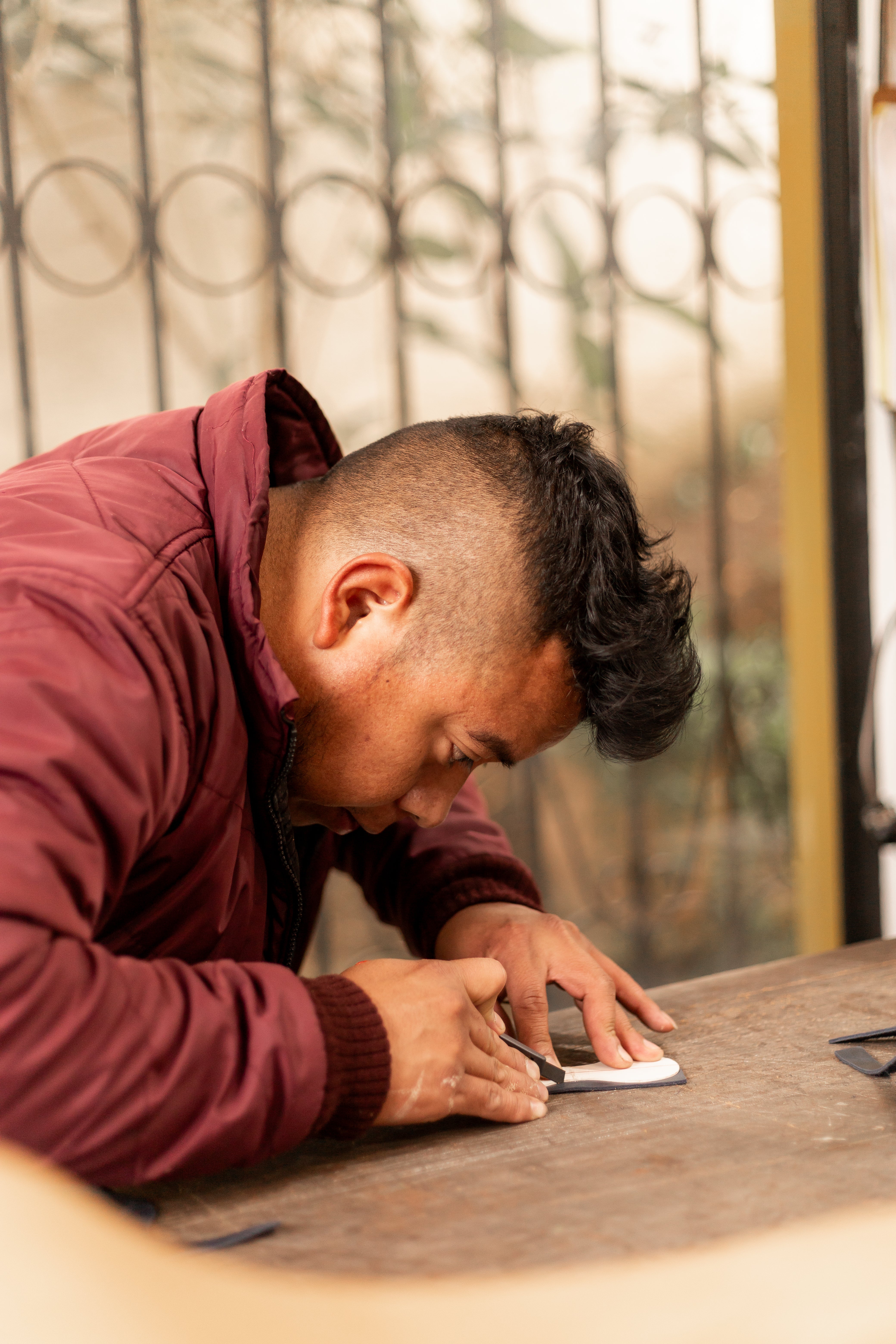 Artisan hand cutting leather