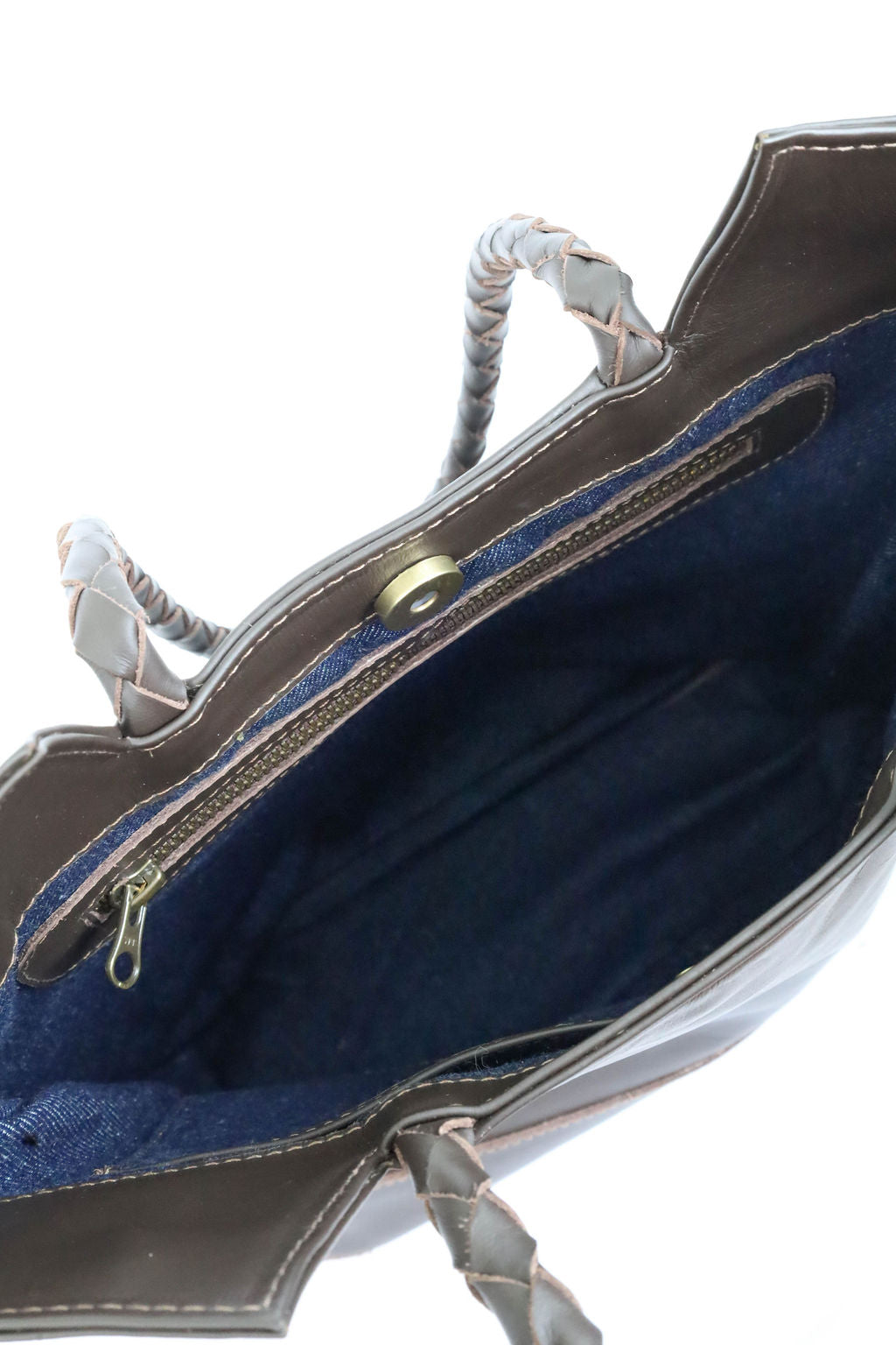Close-up of a handbag with blue interior.