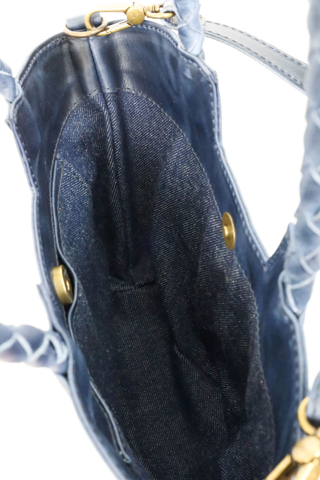 Close-up of a denim lining in handbag on a white background