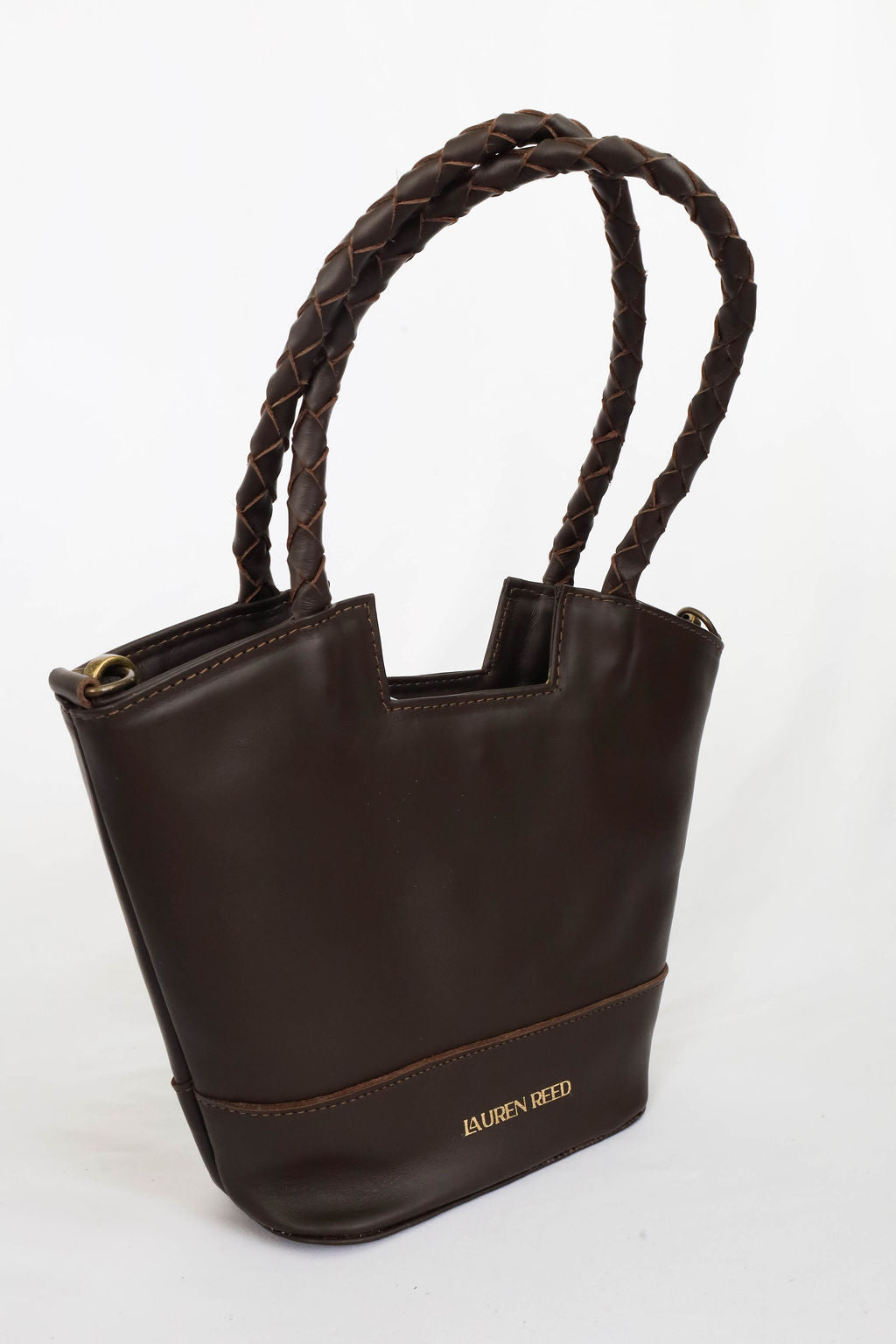 Leather handbag with braided handle on a white background