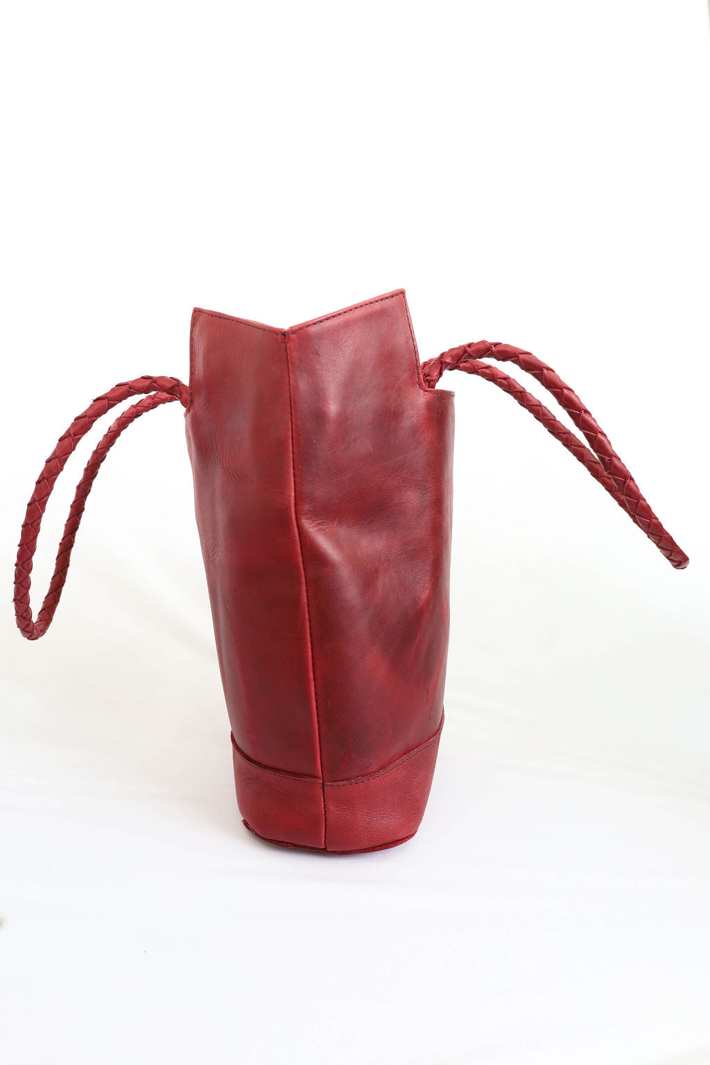 Red leather bag with handles on a white background