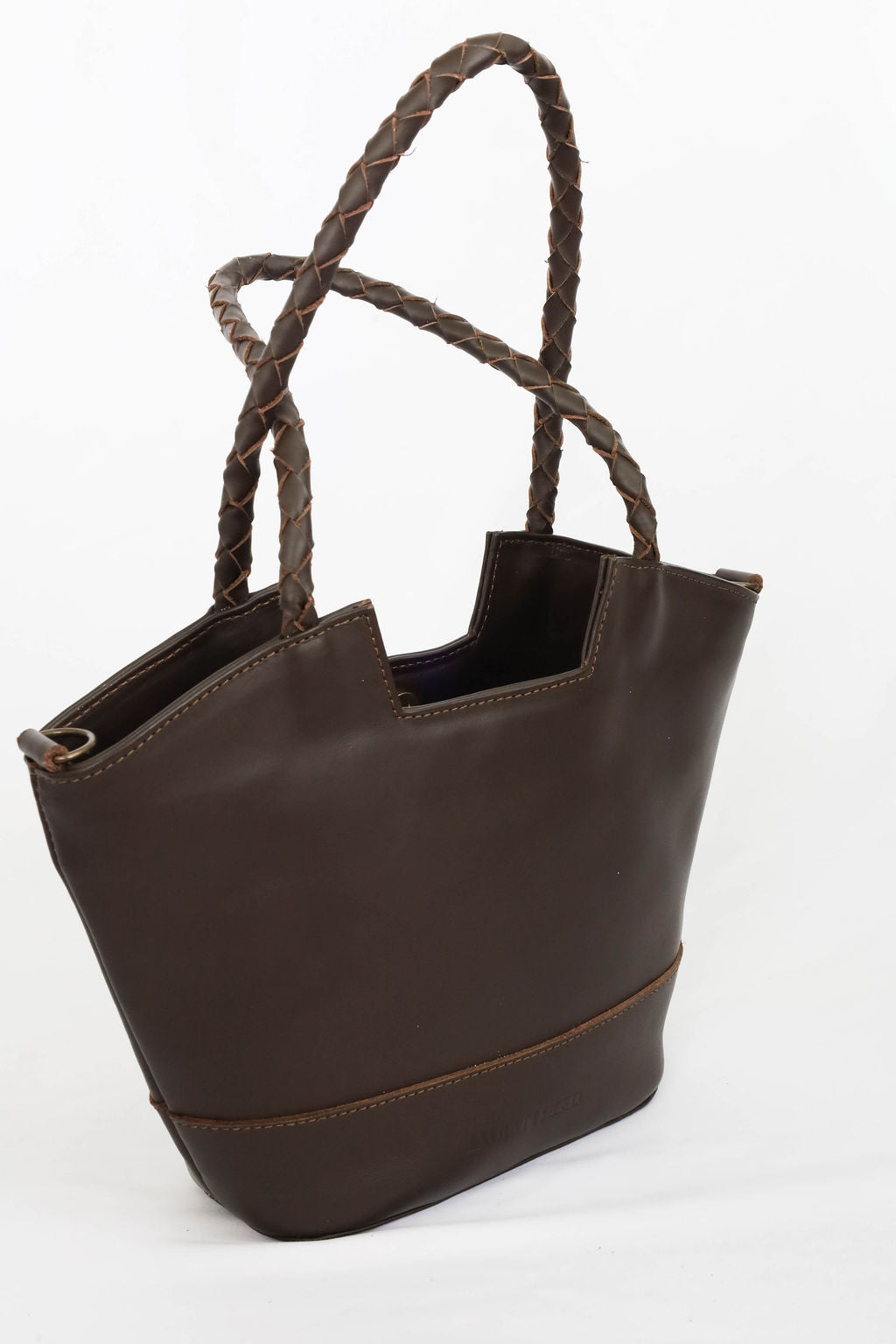 Brown leather handbag with braided handles on a white background