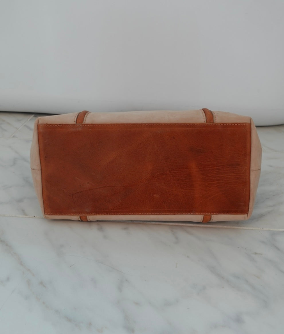 Leather bag on a marble surface with a white background