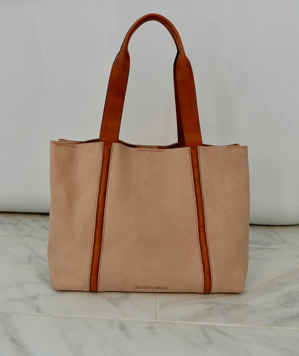 Beige tote bag with brown accents on a marble surface