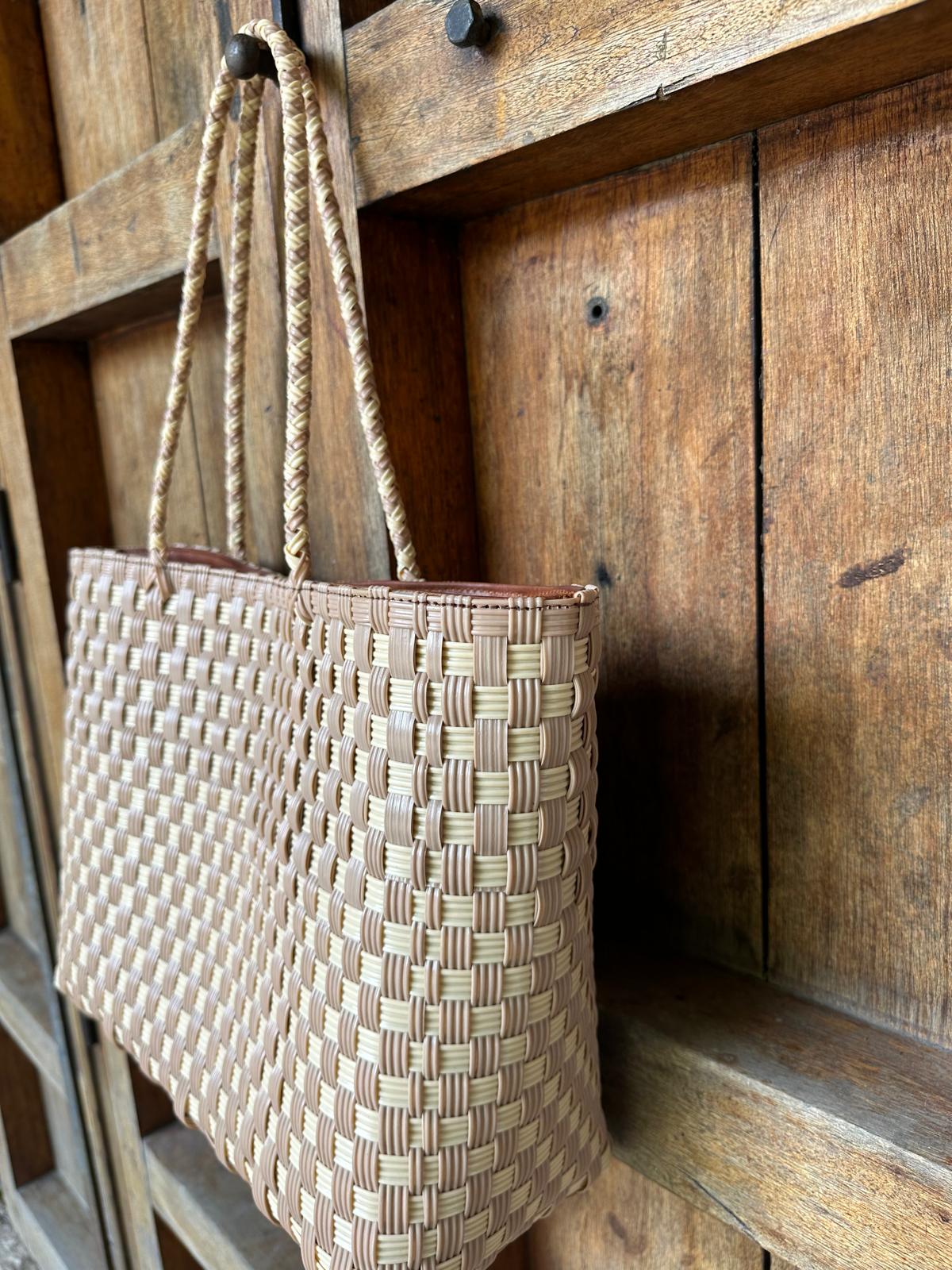 Close up of handwoven upcycled plastic tote bag in tan and cream made by Guatemalan artisans