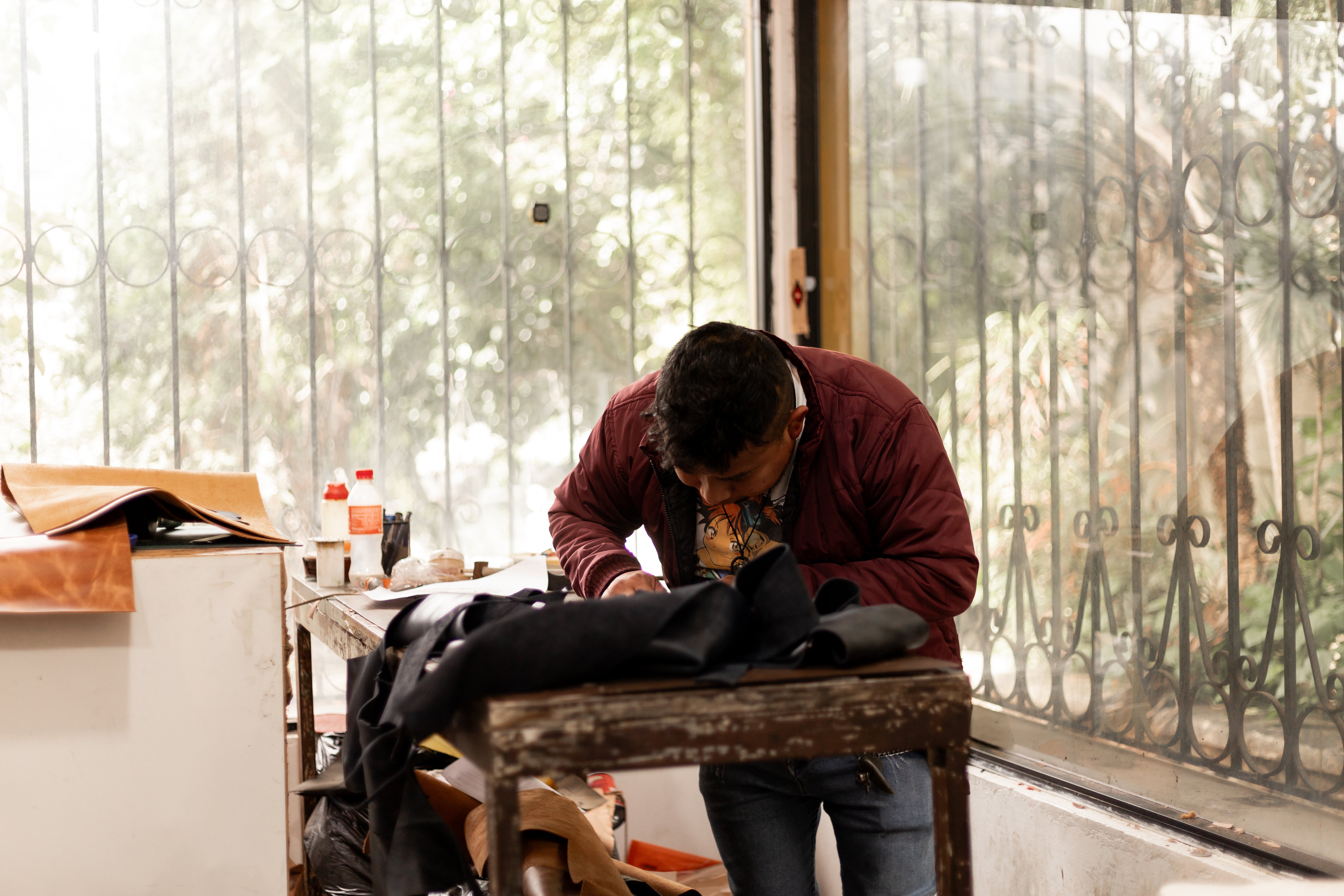 artisan working on handmade purse