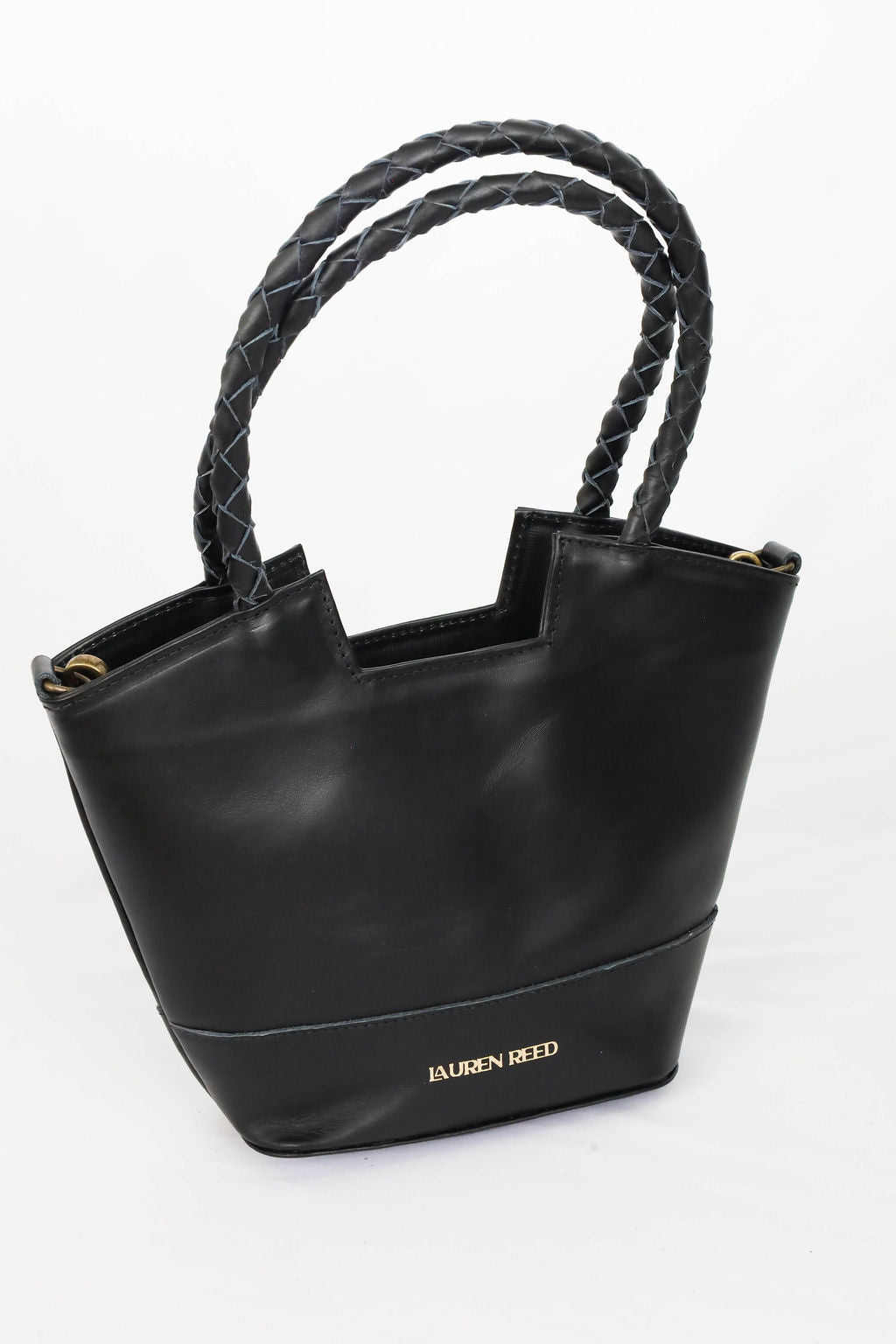 Black handbag with braided handles on a white background