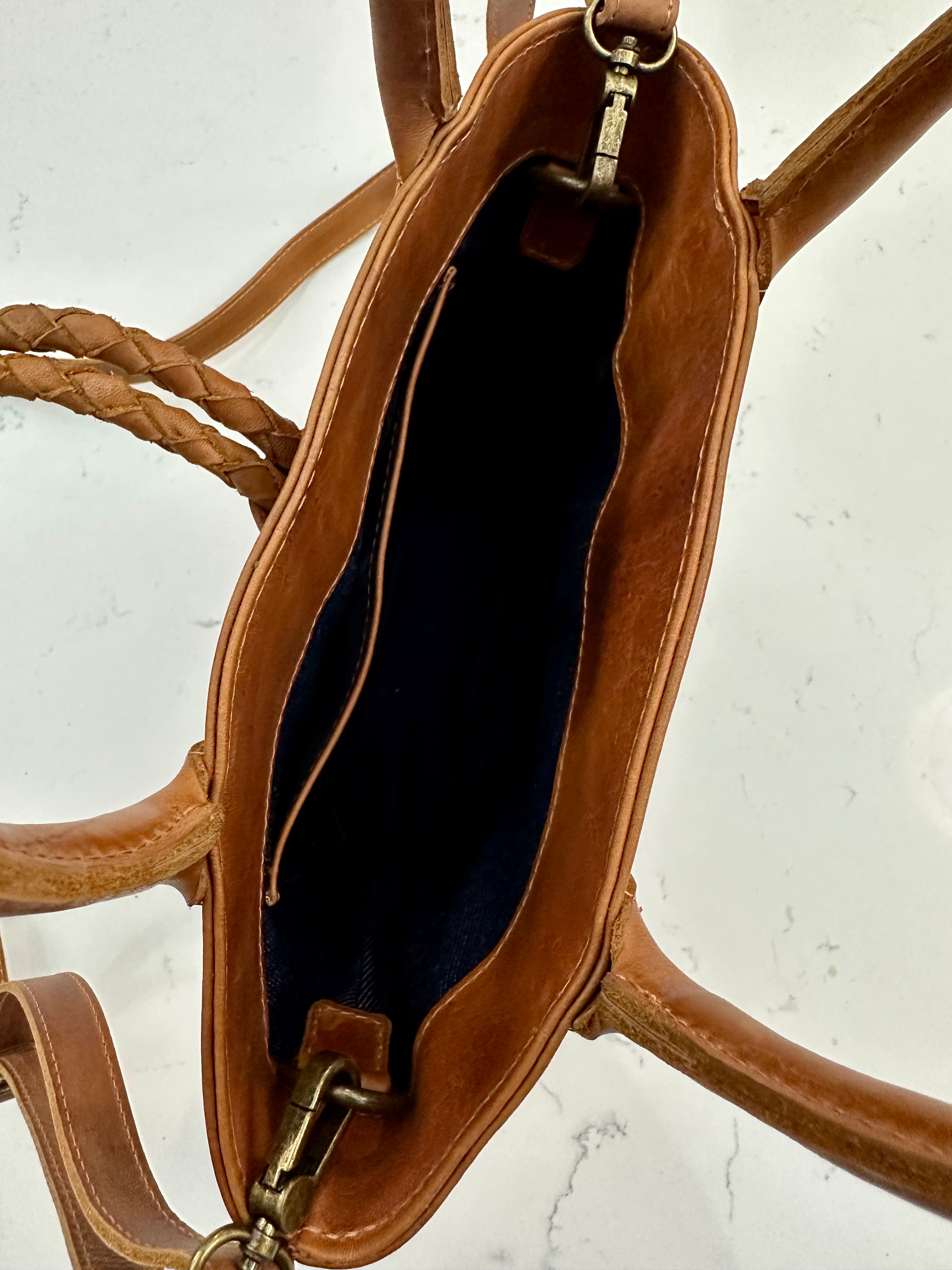 Tan leather handbag interior shot on a white background