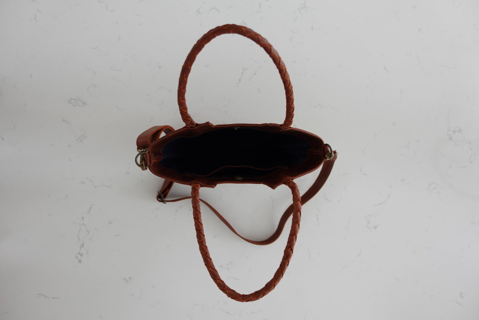 Brown leather purse interior on a light gray background