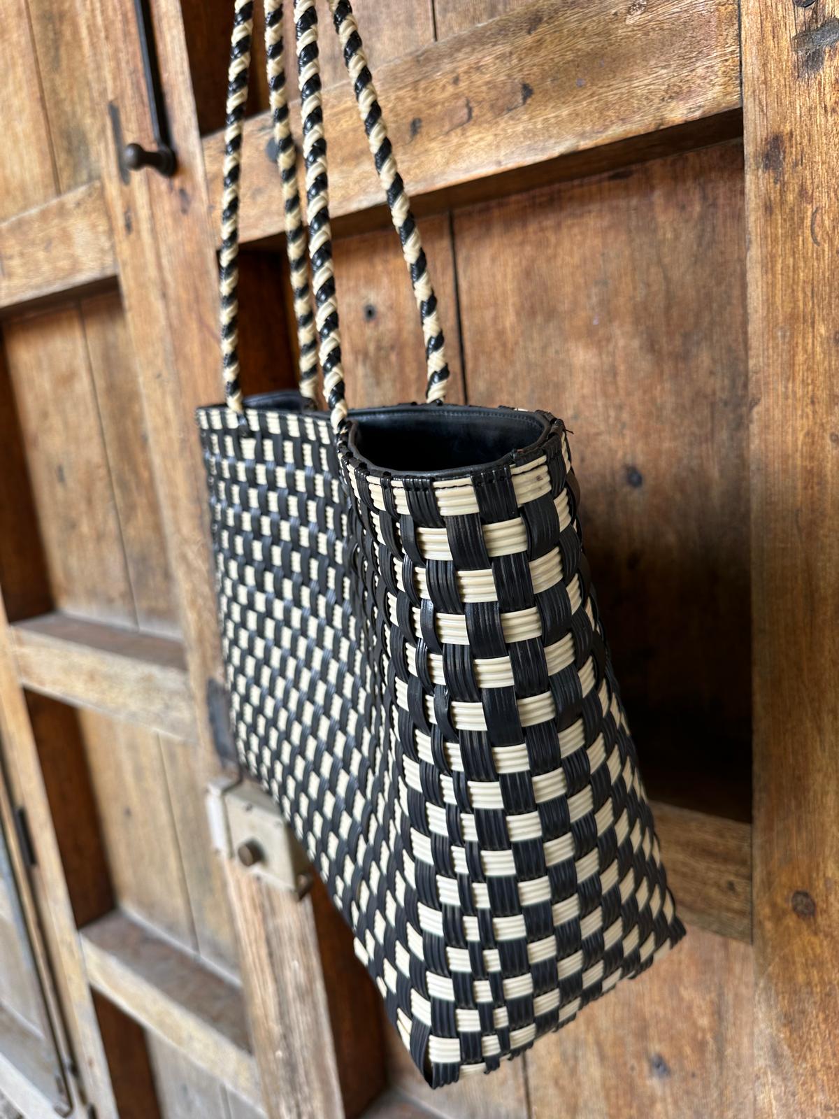 Handmade sustainable beach bag in black and cream with upcycled denim lining