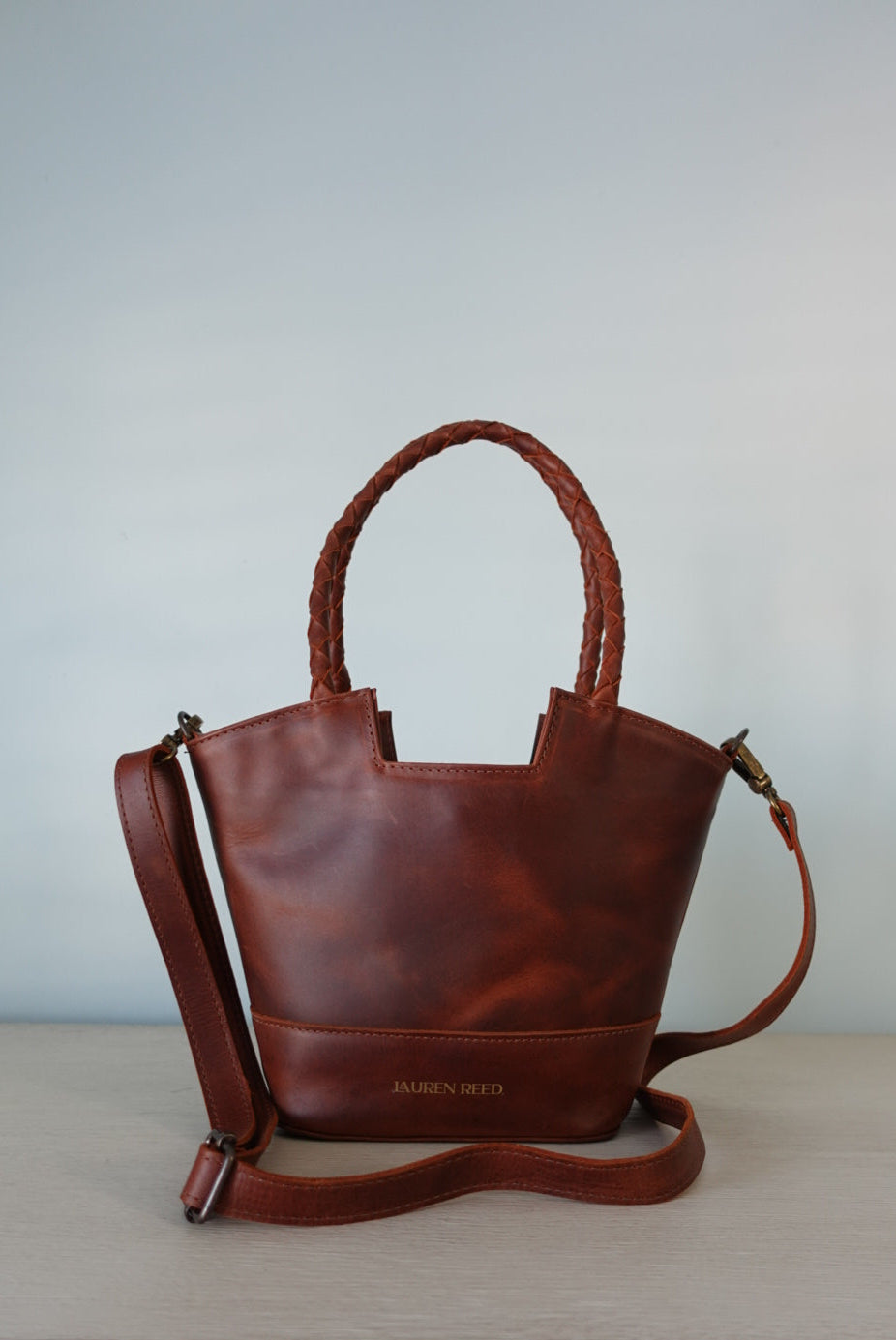 Brown leather handbag branded from Lauren Reed Co