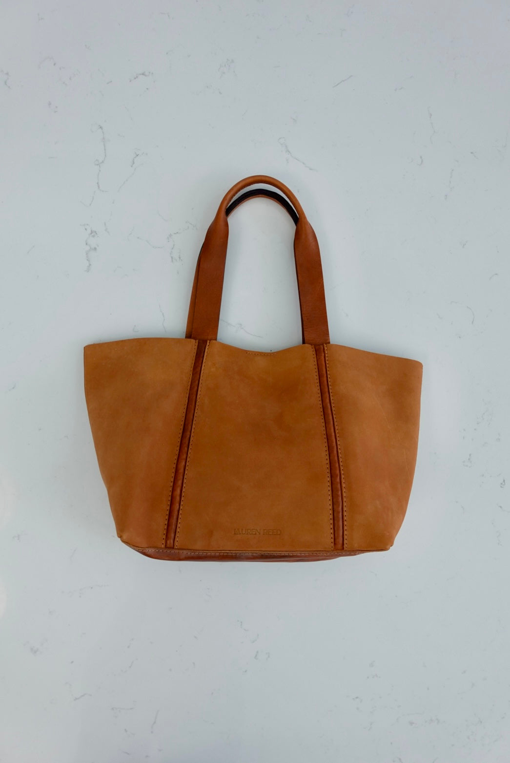 Tan Nubuck leather tote bag on marble 