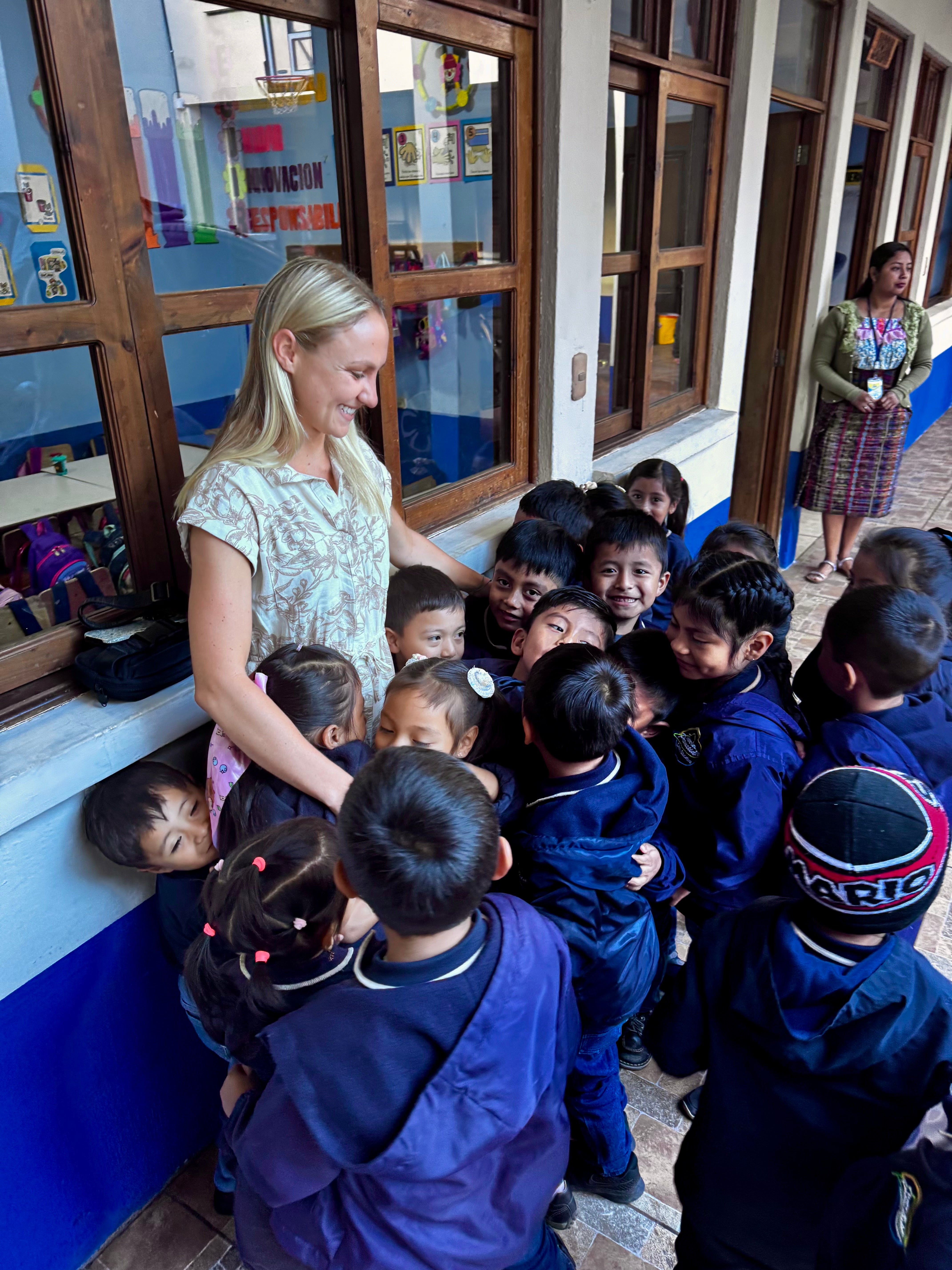 Lauren Reed interacting with a group of children in a Guatemala 